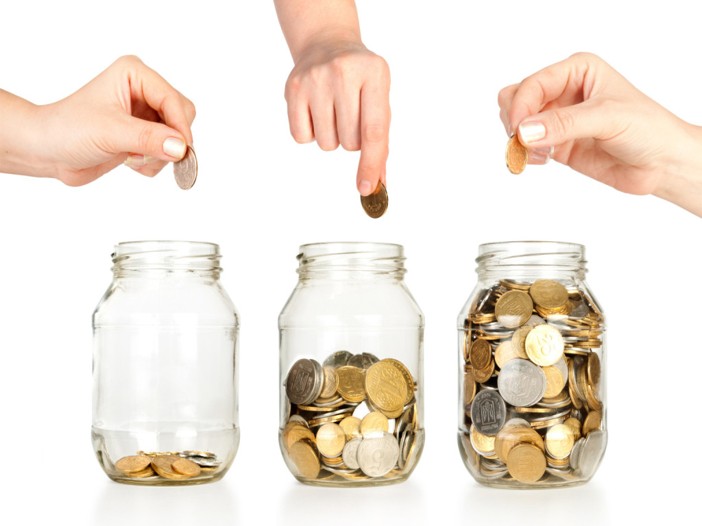 Glass banks for tips with money like diagram and hand
