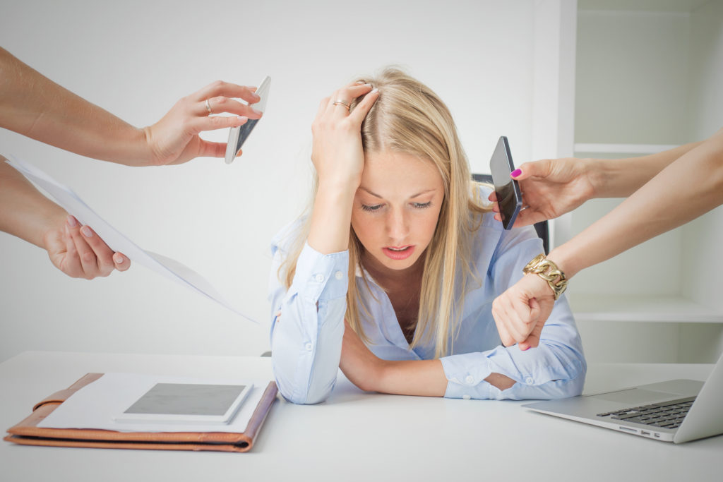 Work issues: woman overloaded with stuff at work